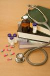 Stethoscope And  Medications On Medical Book Stock Photo