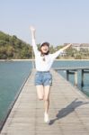 Portrait Of Young Beautiful Woman Jumping With Happy Emotion On Stock Photo