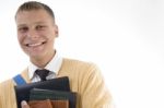 Smiling Student Holding Books Stock Photo