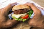 Hand Holding Ham Burger Ready To Eating Stock Photo