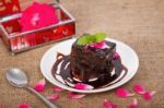 Chocolate Brownie On Plate With Rose Petals Stock Photo