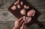 Cutting Raw Chicken Fillet On The Wooden Board Top View Stock Photo