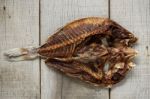 Dried Fish On Wooden Stock Photo