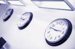 Wall Clocks Showing Different Time Stock Photo