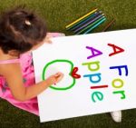 Girl Drawing Apple Shows Learning Stock Photo