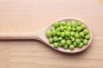 Peas On Wooden Spoon Stock Photo