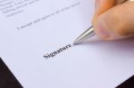 Fingers Holding Pen Writing Signature Stock Photo