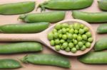 Peas On Wooden Spoon Stock Photo