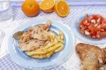 Turkey Steak With French Fries And Tomato Salad Stock Photo