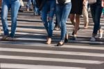 Feet Of Pedestrians Walking On The Crosswalk Stock Photo