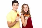 Young Lovers Posing With Pizza Slice In Hand Stock Photo