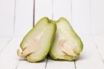 Chayote Fruit On White Wood Background Stock Photo