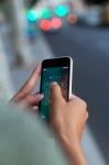 Mobile Phone In A Woman's Hand In The City At Night Stock Photo