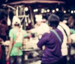 Blurred People Buying Food On The Street At Night Stock Photo