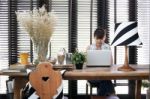 Young Asian Working Woman Is Using A Laptop With Vintage Decoration Stock Photo