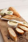 Baguette With Herb Butter And Rosemary Thyme On Rustic Wooden Background Stock Photo