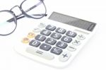 Calculator With Eyeglasses Isolated On White Background Stock Photo