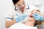 Dentist Curing A Woman Teeth Stock Photo