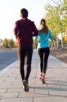 Beautiful Couple Running In The Street Stock Photo