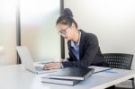 Attractive Women In Casual Business Sitting At A Table Working O Stock Photo