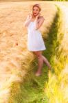 Lonely Beautiful Young Blonde Girl In White Dress With Straw Hat Stock Photo