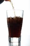 Pouring Brown Soda Into Glass Stock Photo