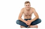 Shirtless Man Sitting On The Floor Stock Photo