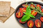 Baked Cherry Tomatoes With Basil And Thyme Stock Photo