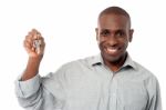 Smiling Man Offering House Key Stock Photo