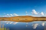 Fishing On A Calm Water. Hills And Sky Stock Photo