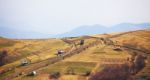 Sunny Spring In Mountain Village. Fields And Hills Stock Photo