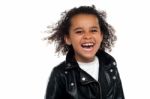 Profile Shot Of An Elementary Kid Laughing Heartily Stock Photo