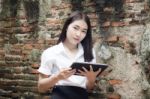 Portrait Of Thai Adult Student University Beautiful Girl Using Her Tablet Stock Photo