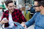 Two Young Entrepreneurs Working At Coffee Shop Stock Photo