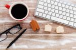 Computer Keyboard With House Model On Wood Background Stock Photo