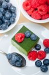 Green Tea Matcha Mousse Cake With Berries Stock Photo