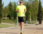 Handsome Young Man Running In The Park Stock Photo