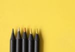 Yellow, Orange, Black Tone Colour Of Black Pencils On Pastel Bri Stock Photo