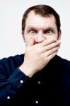 Man Covering His Mouth With His Hand Stock Photo