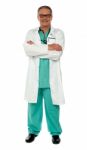 Senior Doctor With Arms Crossed Stock Photo