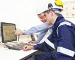 Engineers Discussing In Front Of Pc Stock Photo