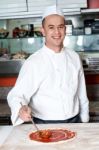 Smiling Chef Making Pizza Stock Photo