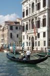 Gondolier Ferrying People In Venice Stock Photo