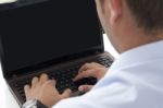 Typing On The Laptop In The Office Stock Photo