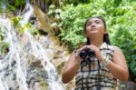 Girl Using Binoculars In Forest Stock Photo