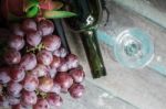 Grapes And Wine Bottles Lying Stock Photo