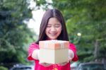 Portrait Of Thai Teen Beautiful Girl In Chinese Dress, Happy New Year And Open Box Gift, Smile And Very Happy Stock Photo