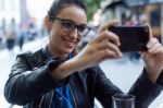 Beautiful Young Woman Using Her Mobile Phone In The Street Stock Photo