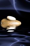 Stones With Reflection In Water Stock Photo