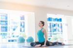 Asian Woman Doing Yoga Indoors Stock Photo